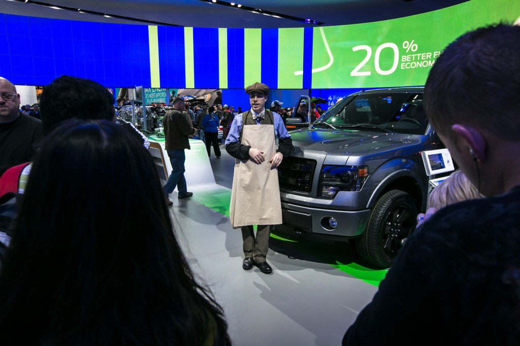 An actor playing Henry Ford with a Ford Truck at the 2013 Detroit Auto Show